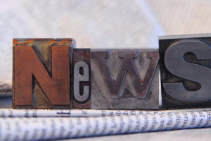 News in block letters on newspapers