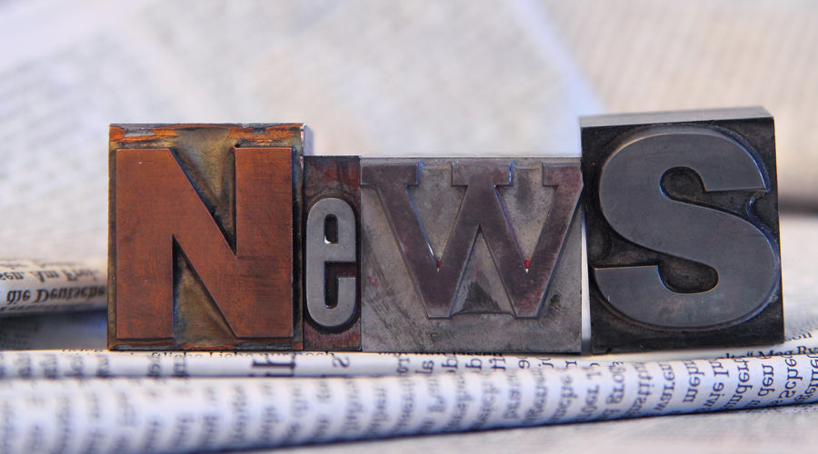 News in block letters on newspapers