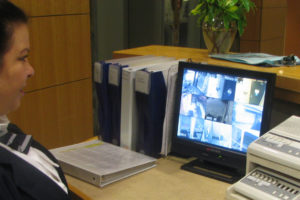 Female security officer monitoring cameras