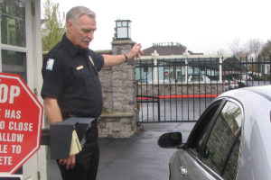 Security officer directing traffic at entrance to apartment building